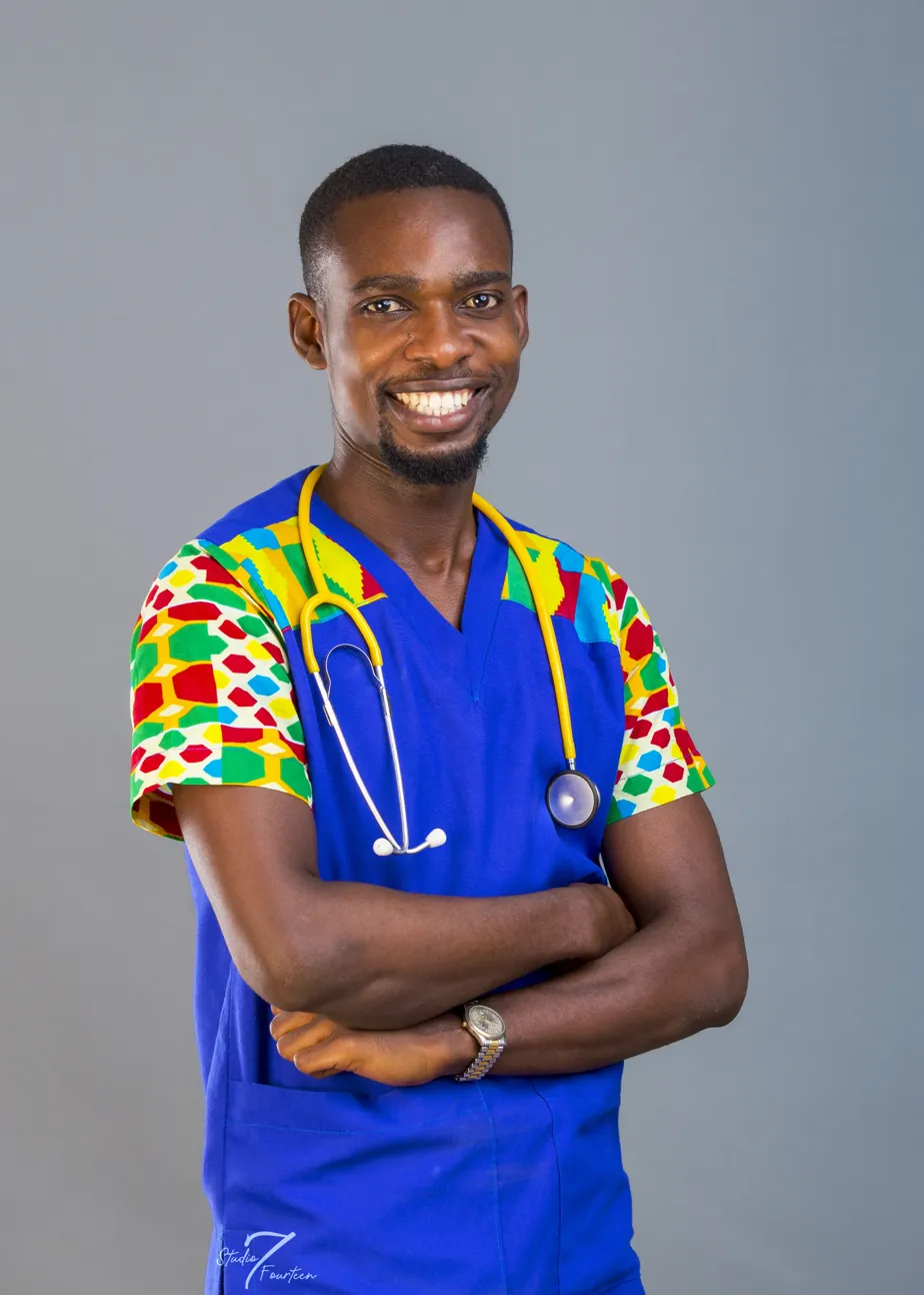 Liahona care team member in blue scrubs with kente sleeves